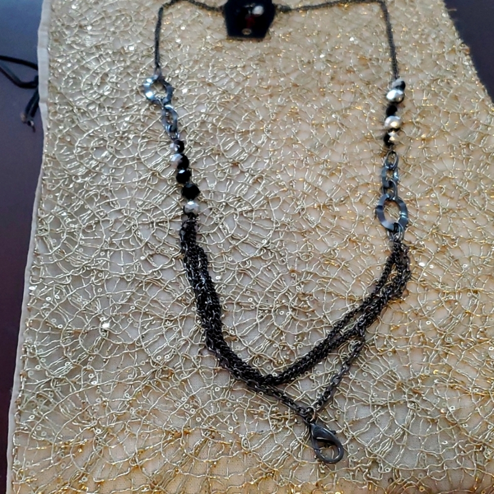 One black long necklace 01 pair of earrings with beads.